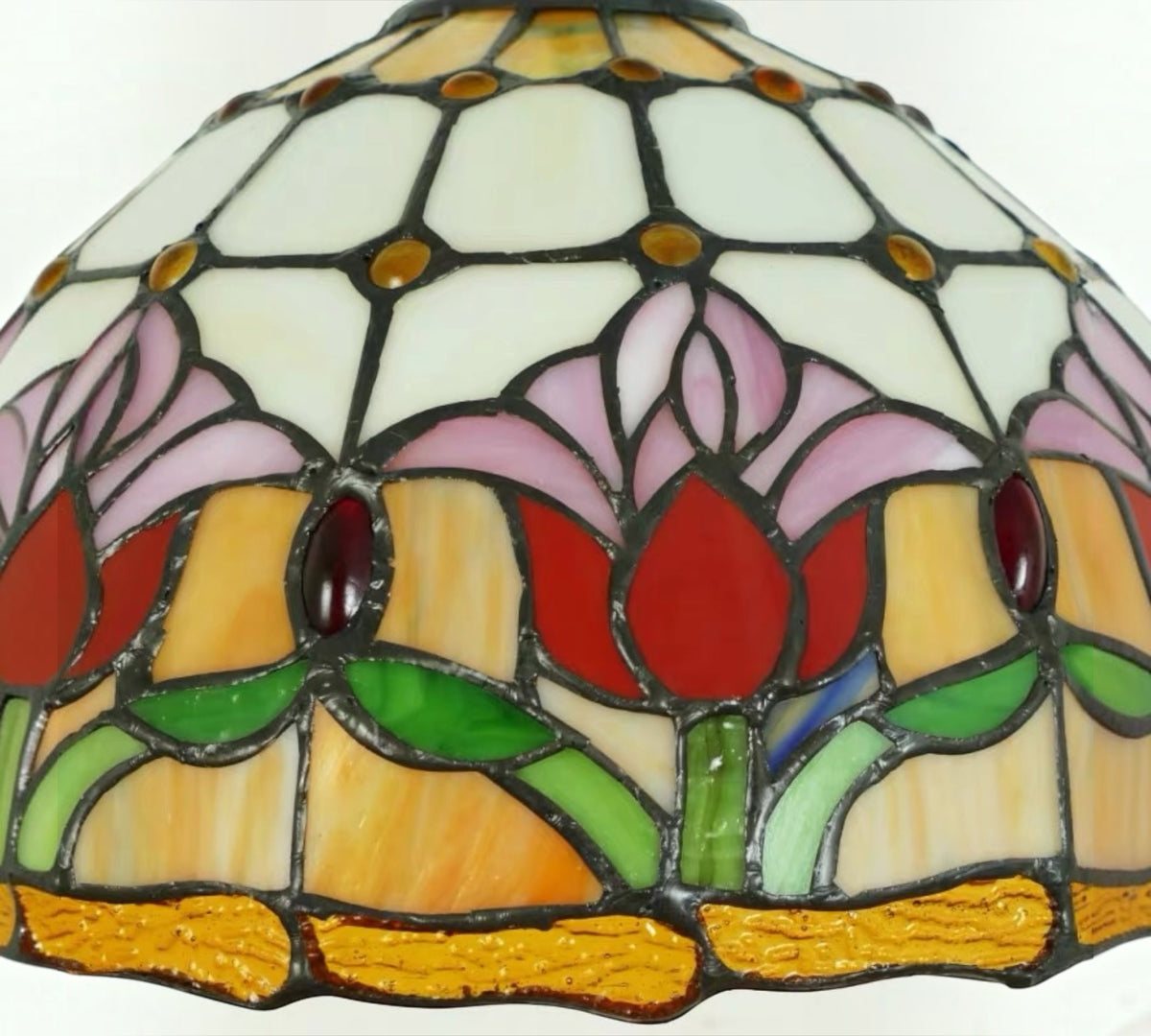 Close-up of stained-glass tulip lamp shade with multicolor floral panels