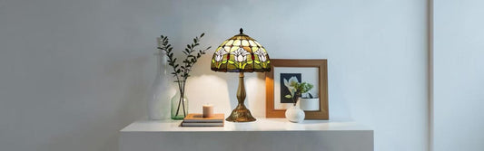 Different sizes of Tiffany stained glass table lamps displayed to show scale comparison for room sizing