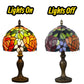 Tiffany-style table lamp showing stained-glass shade lights on vs lights off