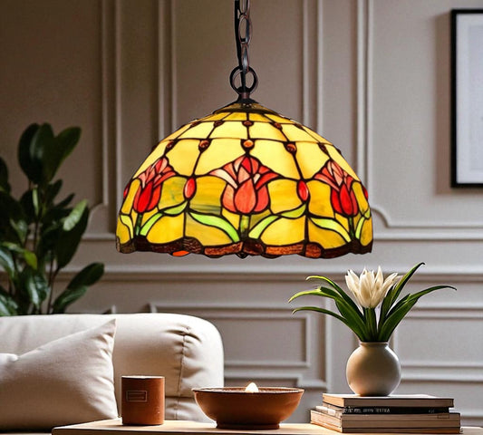 Stained glass pendant lamp with warm yellow shade, red tulips, and green leaf accents