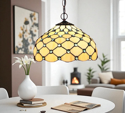 Tiffany-style pendant lamp with stained glass yellow shade, blue accents, and hanging chain