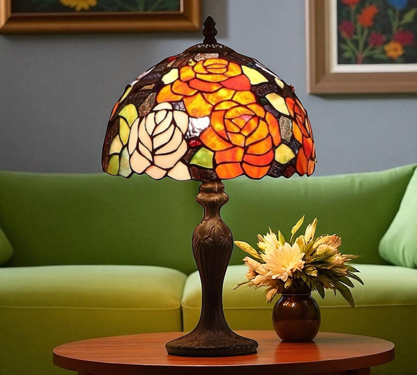 Stained glass lamp on a table with a green sofa and floral arrangement in the background. CDH Tiffany Table Lamp