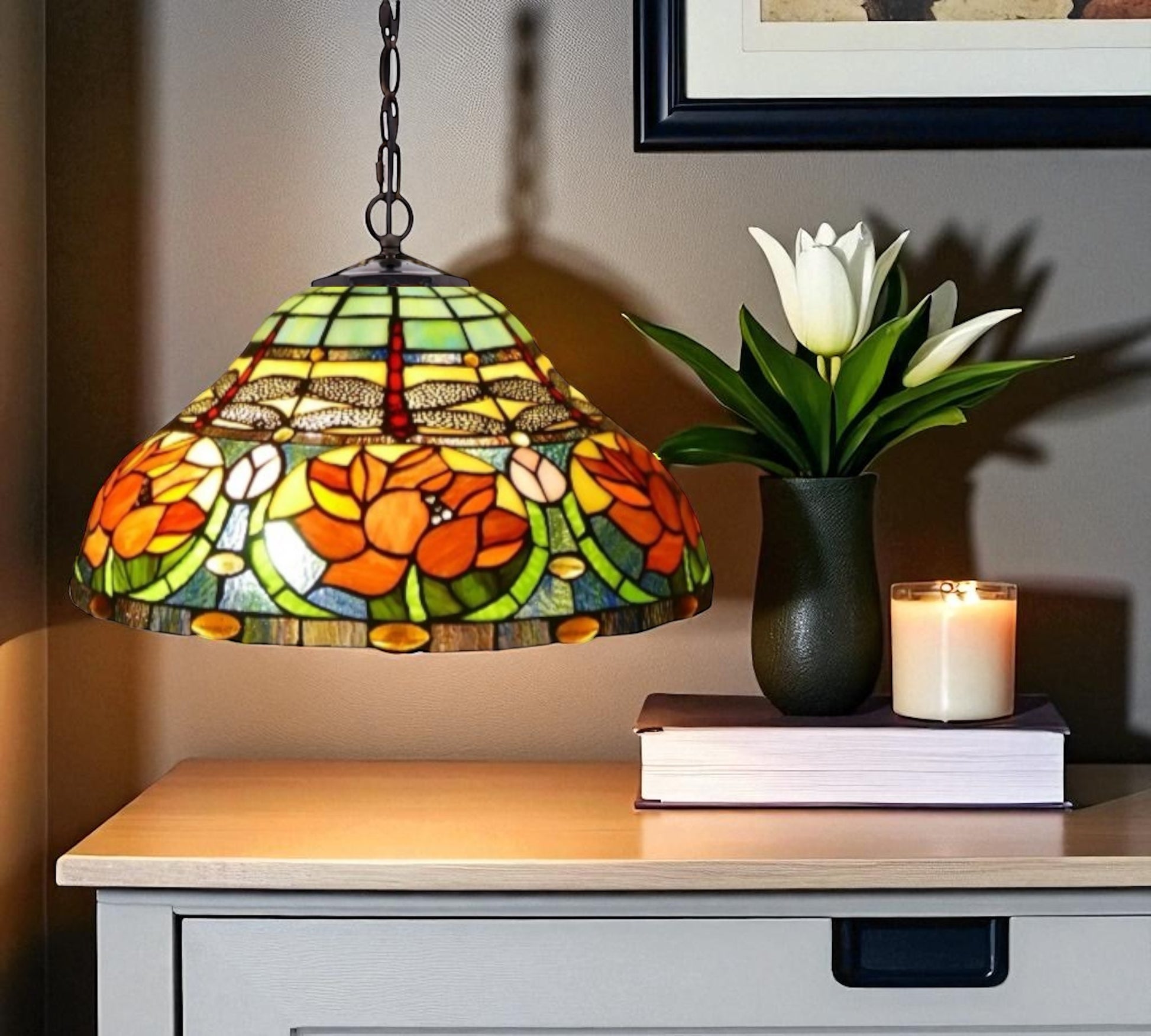 Stained glass lamp with floral design on a wooden surface with a candle and plant. NZ#1 Tiffany Lamp Seller