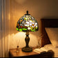 Tiffany-style stained glass table lamp with multicolor shade and bronze base