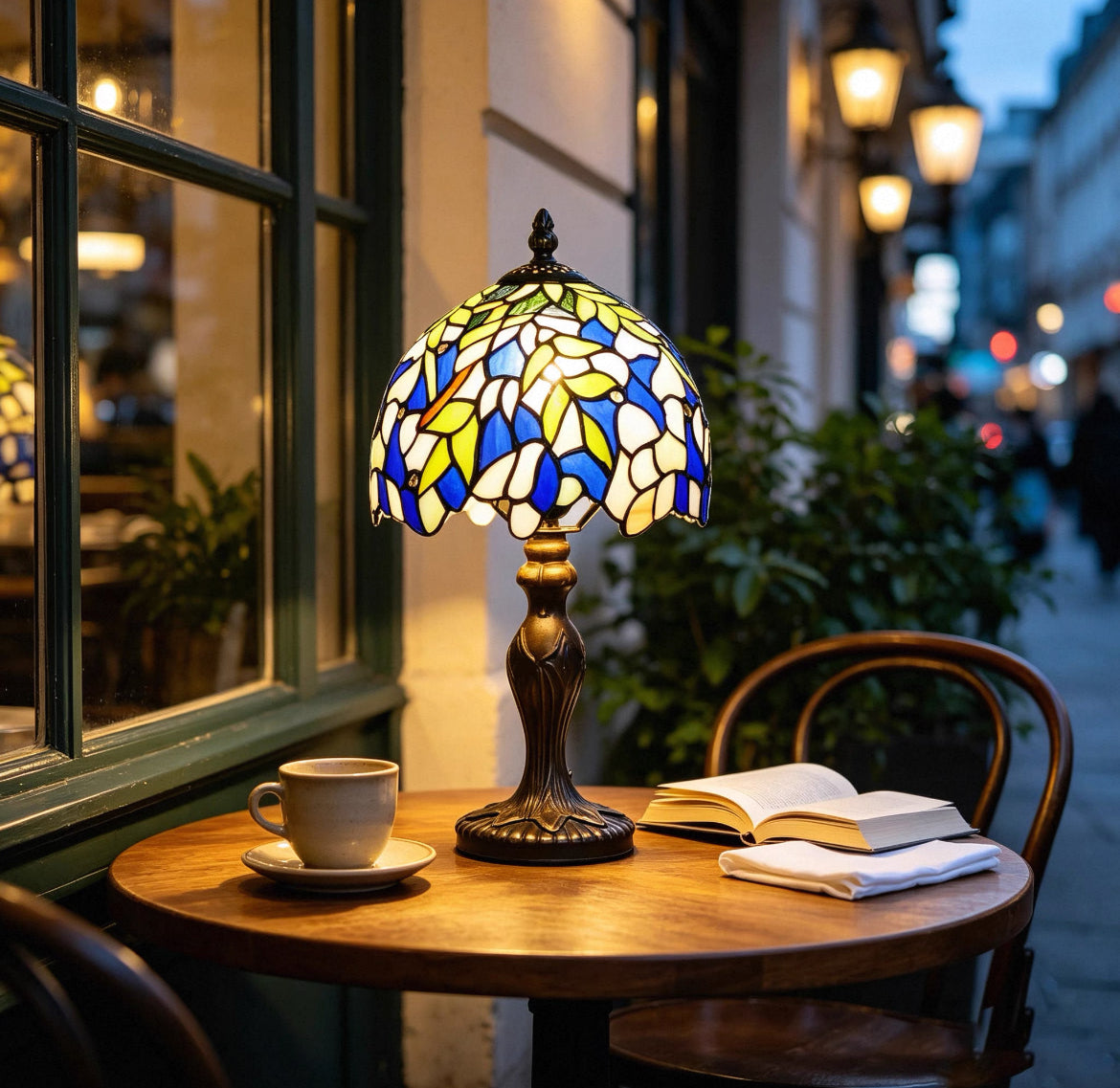 Tiffany table lamp with stained glass dome shade in blue, yellow, and white; bronze base