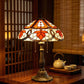 Tiffany table lamp with stained glass shade and bronze metal base, decorative pull chains