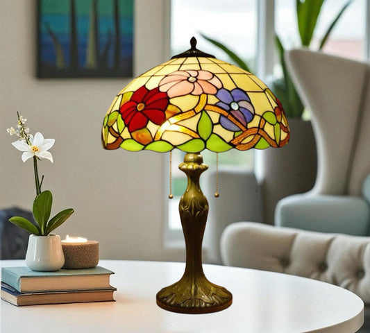 Table lamp featuring a multicolor stained-glass dome shade with pull chains and metal base