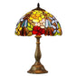 Stained glass Tiffany table lamp with domed floral shade and bronze metal base