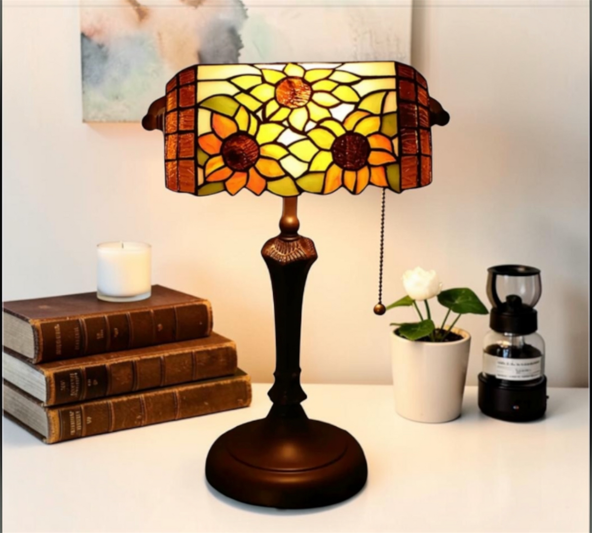 Tiffany table lamp with stained-glass floral shade and dark metal base, pull chain