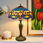 Tiffany-style table lamp with multicolor stained glass shade and bronze base, pull-chain detail
