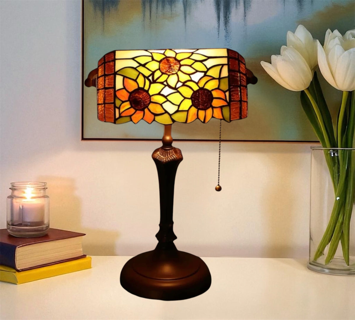 Stained-glass table lamp with yellow floral shade and dark metal pedestal base