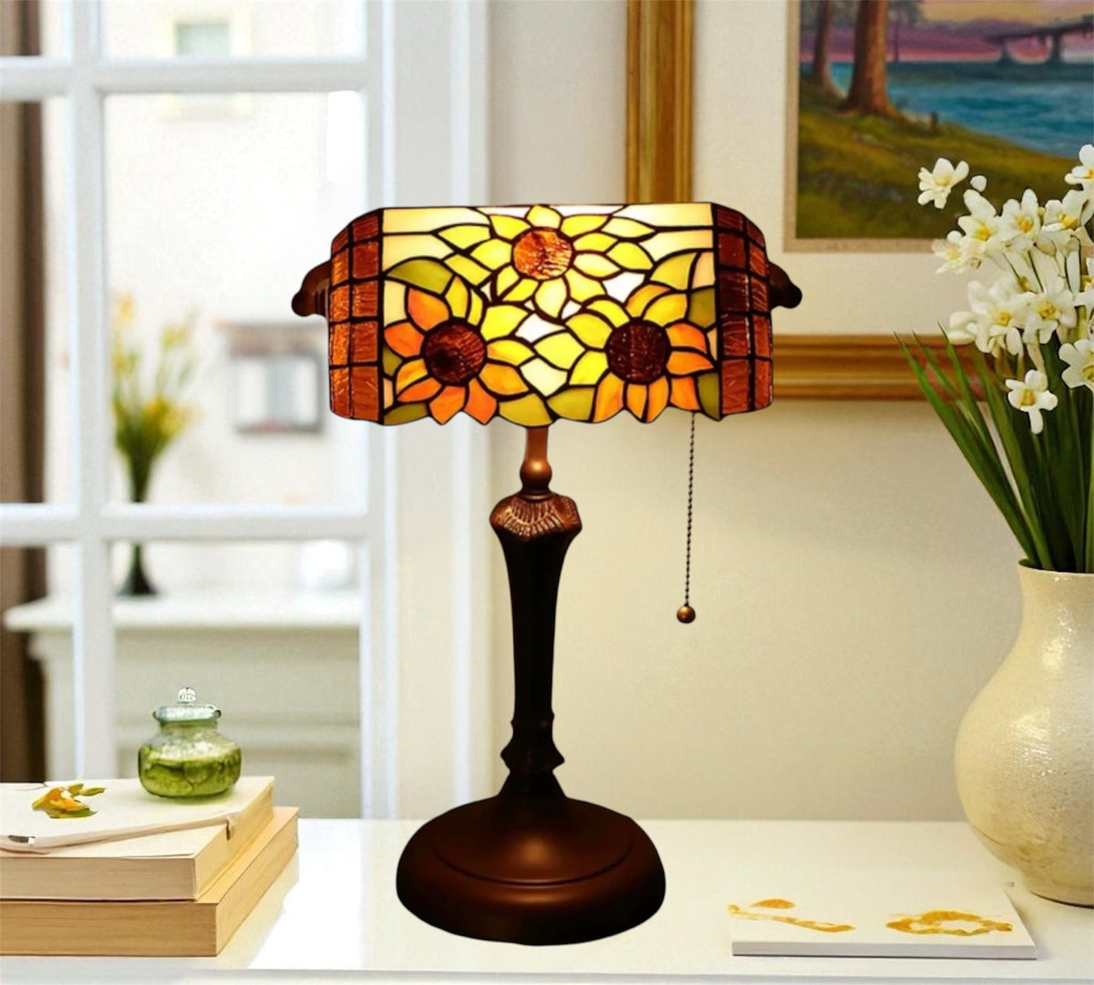 Stained-glass table lamp with scalloped yellow floral shade and dark metal base, pull cord