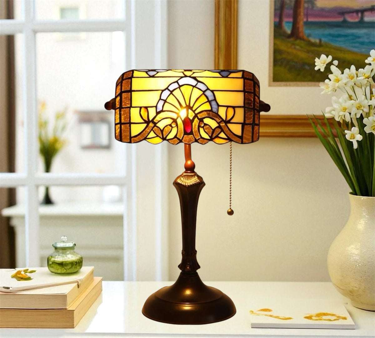 Stained glass table lamp with amber shade over dark bronze pedestal base