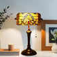 Stained glass table lamp with amber shade and dark bronze base with pull chain