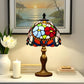 Front view Tiffany table lamp with multicolor stained-glass shade and bronze base