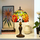Tiffany-style stained glass table lamp with multicolor curved shade and dark bronze base