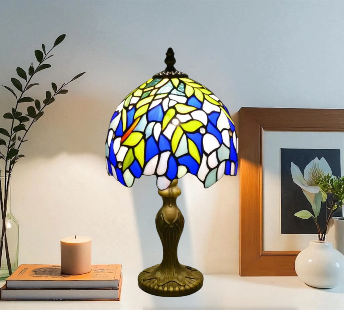 Tiffany table lamp with stained glass dome shade in blue, yellow, and white; bronze pedestal base