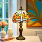 Stained glass table lamp with multicolor tulip-style shade and bronze base