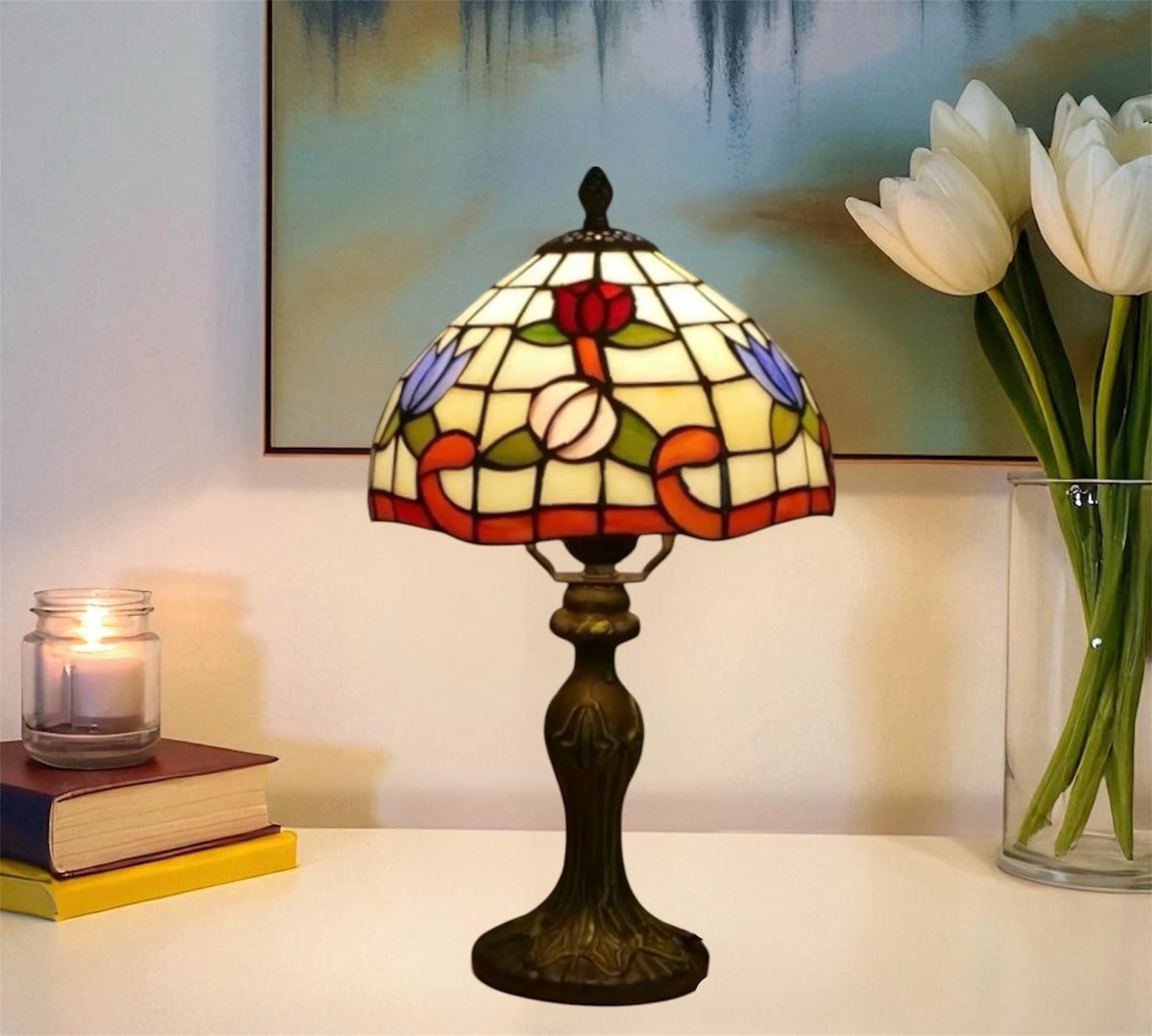 Tiffany-style stained glass table lamp with red floral shade and bronze base on tabletop.