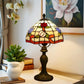Stained glass table lamp with multicolor floral shade and dark metal base