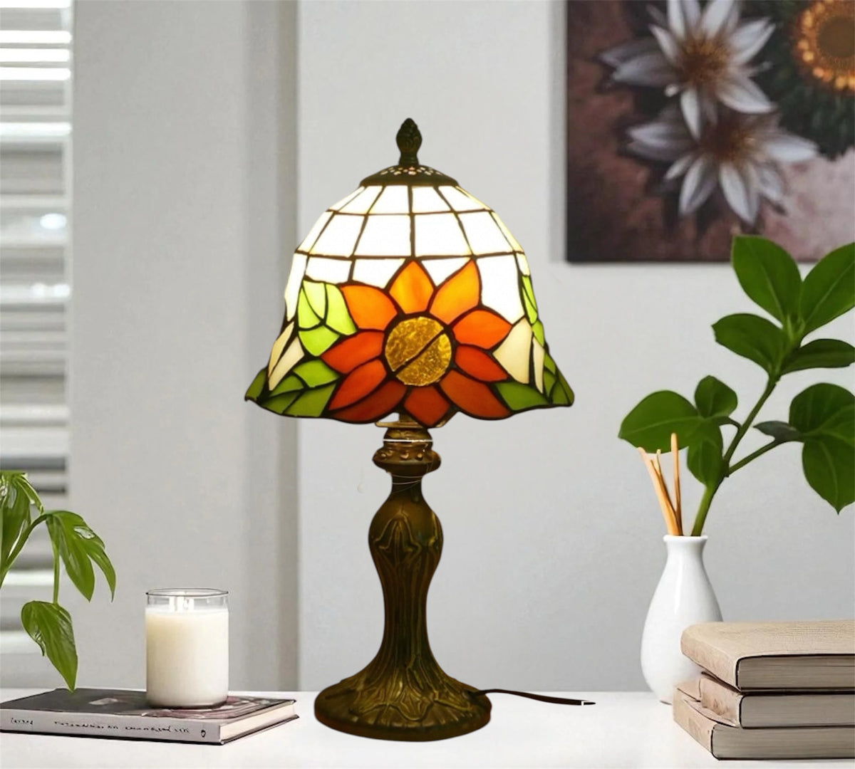 Tiffany-style stained glass table lamp with orange flower shade and ornate dark bronze base