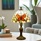 Tiffany table lamp with stained-glass shade and orange butterfly motif, bronze base on table