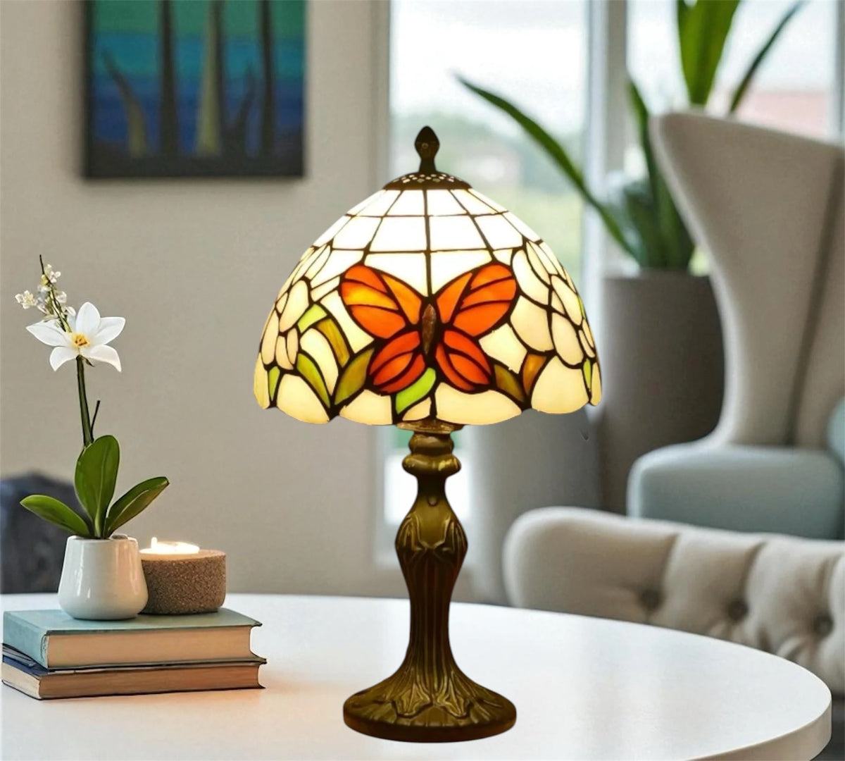 Tiffany table lamp with stained-glass shade and orange butterfly motif, bronze base on table