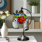 Decorative stained glass rose table lamp with multicolor shade and curved metal base