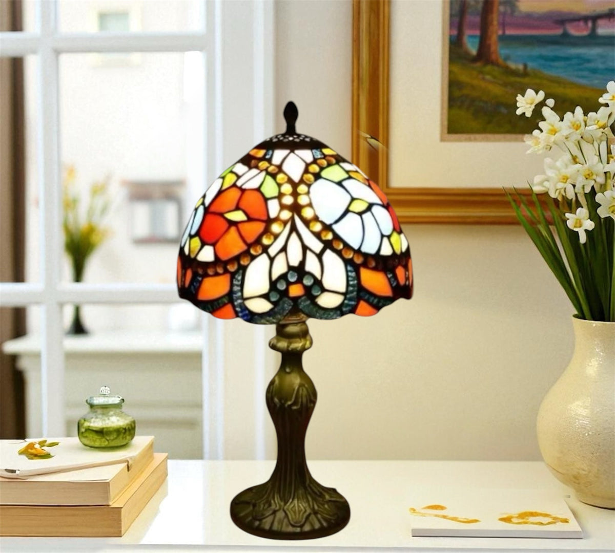 Tiffany table lamp with multicolor stained-glass shade and bronze base on tabletop