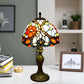 Tiffany table lamp with multicolor stained-glass dome shade and dark bronze pedestal base