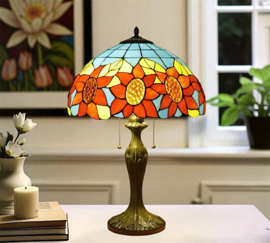 Tiffany-style table lamp with stained glass floral shade and ornate gold-tone base