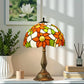 Tiffany-style table lamp with stained-glass flower shade and bronze base, side view