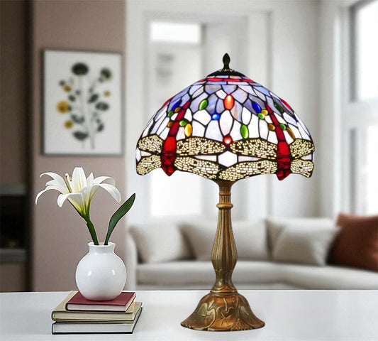 Tiffany style stained glass table lamp featuring a multicolor arched shade and bronze base