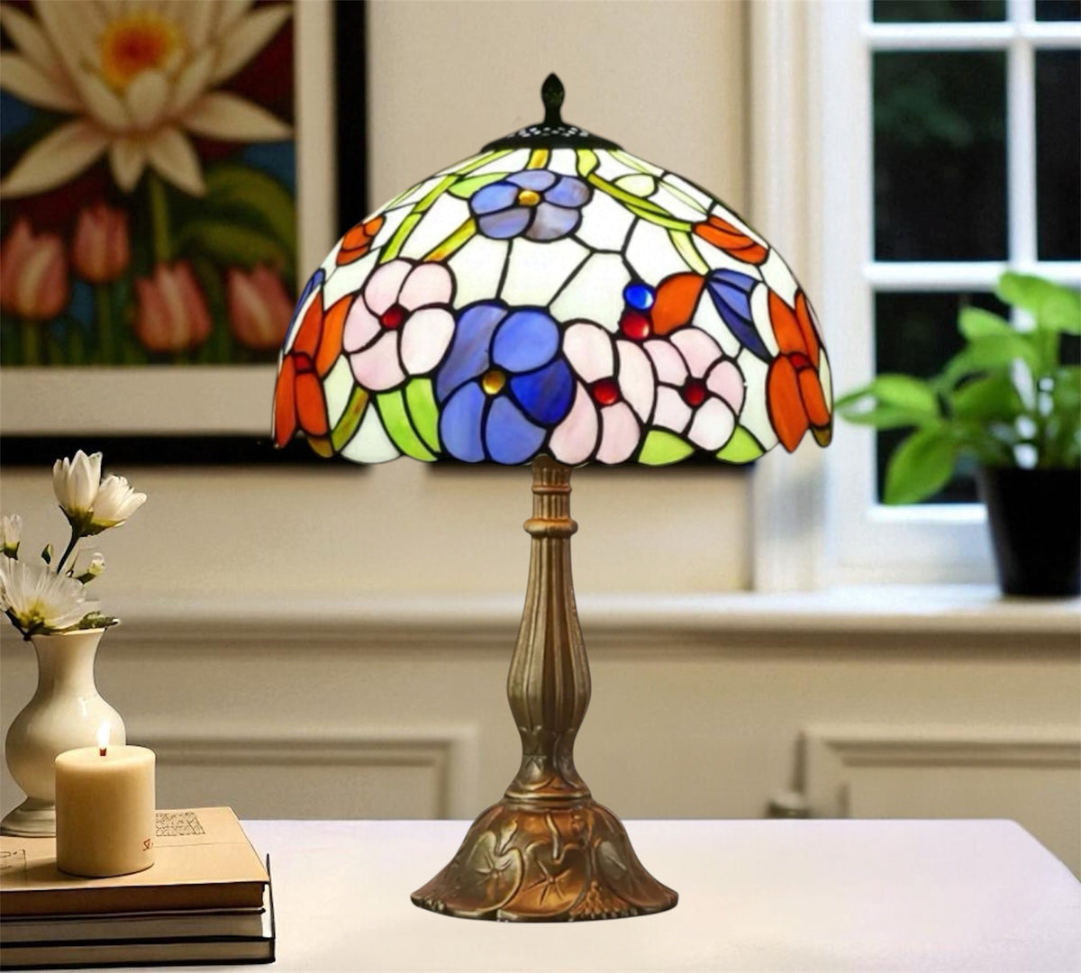 Domed stained glass table lamp with colorful floral pattern and bronze-toned metal base.