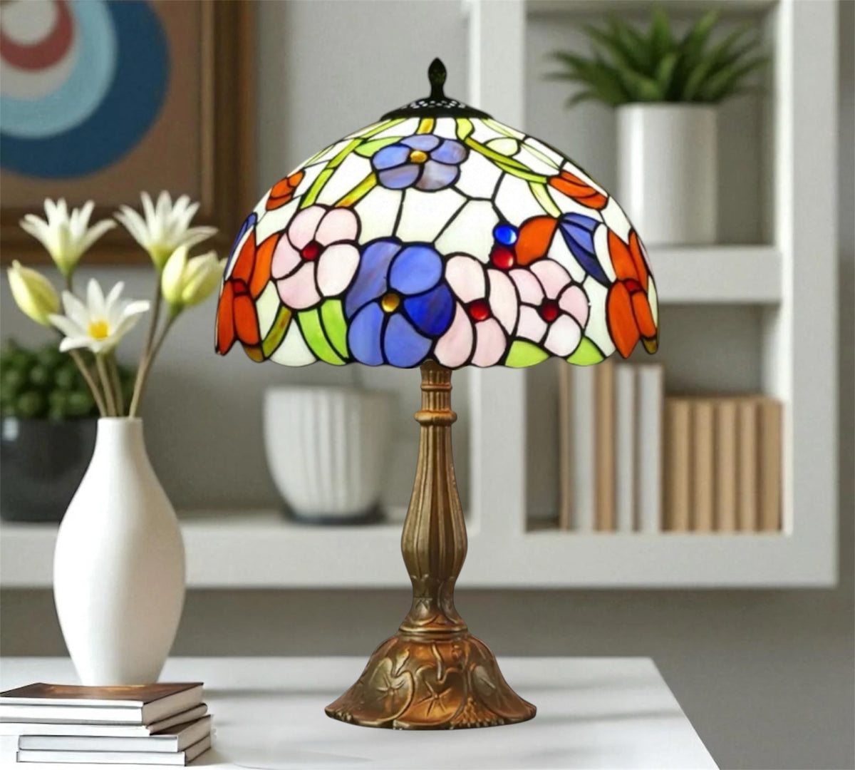 Stained glass table lamp with domed floral shade and bronze-toned pedestal base.
