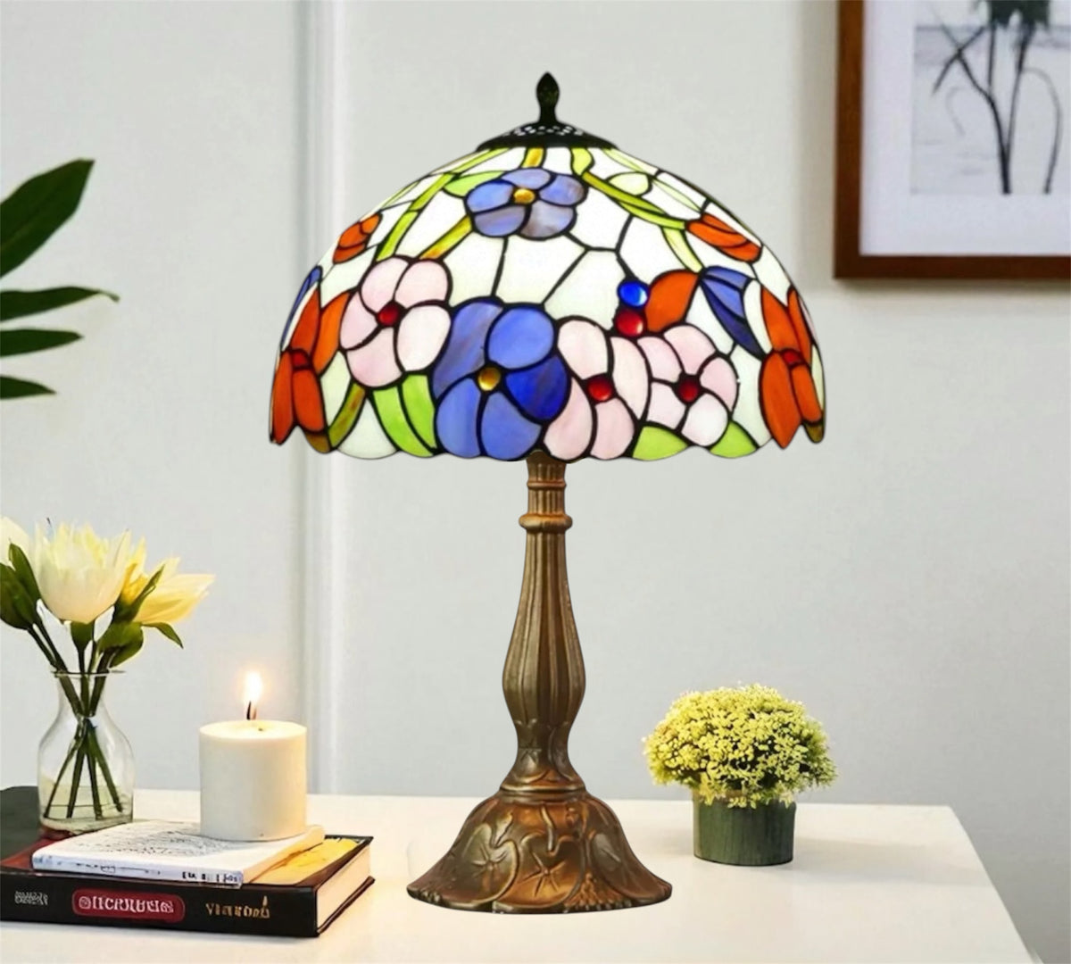 Multicolor stained glass table lamp with domed floral shade and ornate bronze base.