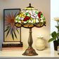 Tiffany-style lamp with stained-glass shade in yellow, red, green, and bronze base