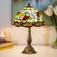 Tiffany-style table lamp with multicolor stained-glass shade and bronze pedestal base