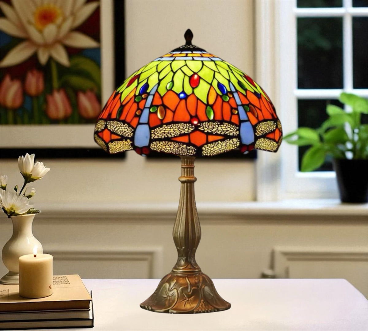 Tiffany-style table lamp with round stained-glass shade in green, orange and red and bronze base