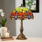 Stained glass table lamp featuring a green-yellow leaf shade with orange and red accents