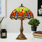 Stained glass table lamp with domed multicolor shade and sculpted bronze base