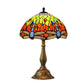 Tiffany-style table lamp with round domed stained-glass shade and bronze pedestal base