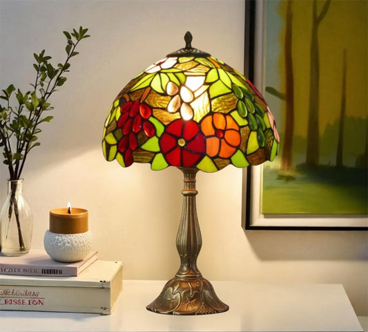 Bronze base stained glass table lamp with domed floral shade and top finial