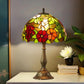 Stained glass table lamp with multicolor floral shade and tall bronze pedestal base