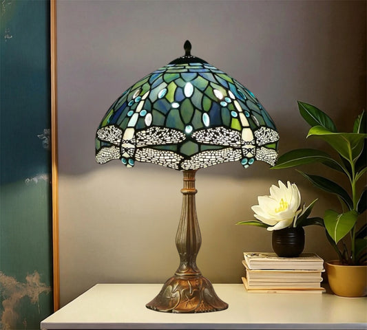 Tiffany stained glass table lamp with green-blue shade and detailed bronze foot