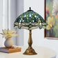 Stained glass table lamp with green-blue dome shade and bronze pedestal base