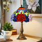 Colorful stained glass table lamp featuring a red rose pattern and bronze pedestal base.