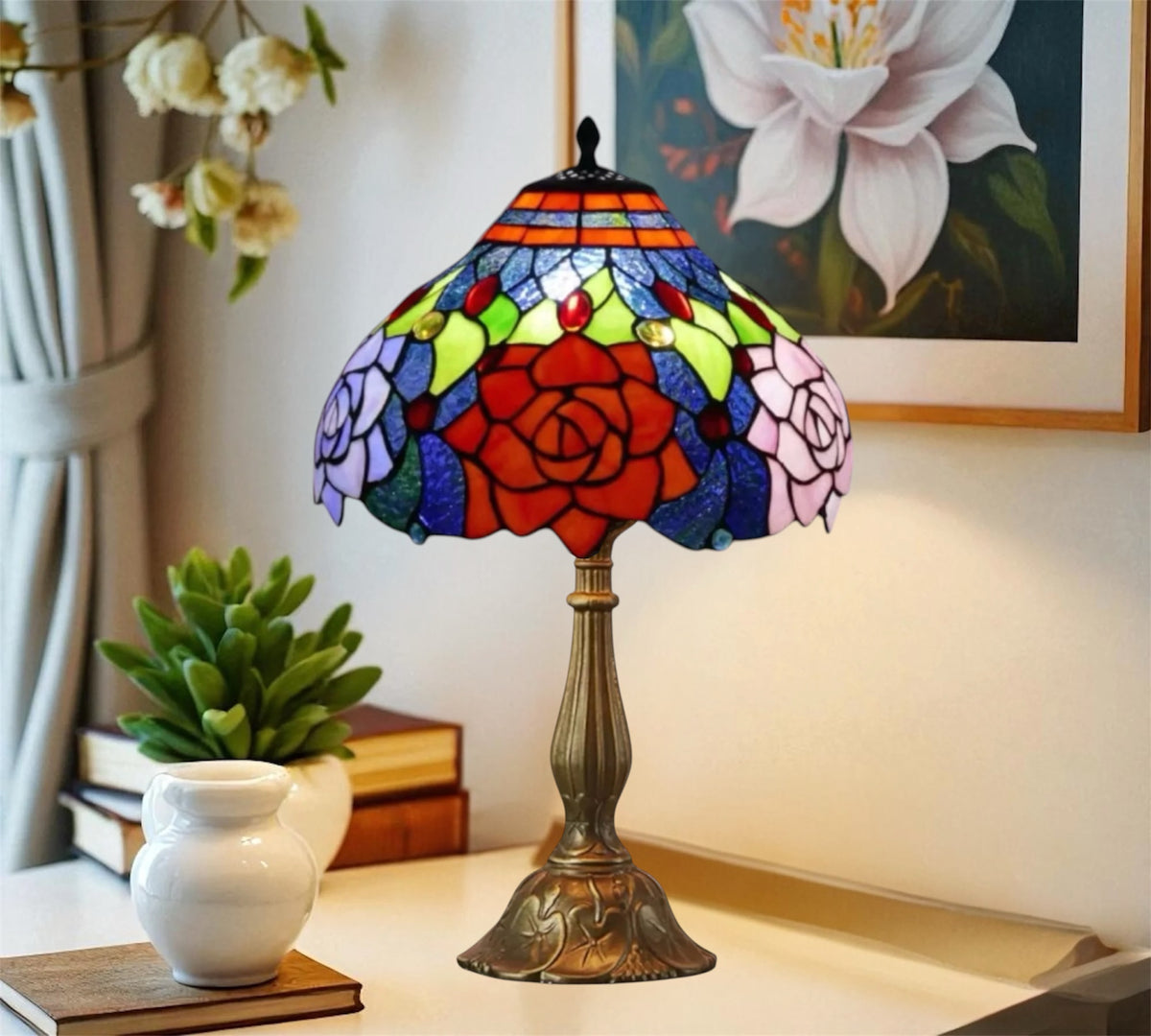 Colorful stained glass table lamp featuring a red rose pattern and bronze pedestal base.
