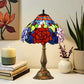 Stained glass table lamp with red rose center, blue and green glass, bronze base.
