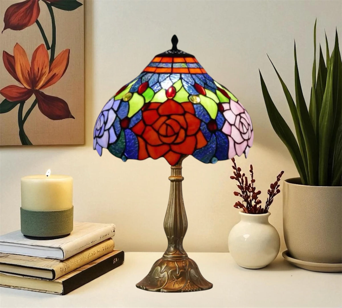Stained glass table lamp with red rose center, blue and green glass, bronze base.